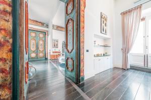an ornate wooden door in a room with wooden floors at Hotel Palazzo Murat in Positano