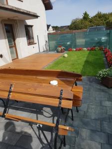 a wooden table and benches on a patio at MOLO APART in Mosty