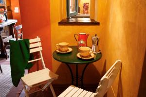 uma pequena mesa com duas chávenas e duas cadeiras em I Veroni - Agriturismo and Wine Cellar em Pontassieve