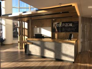 an office with a reception desk in a building at ibis budget Paris Porte de Montreuil in Montreuil