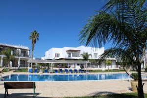 a resort with a swimming pool and a building at Апартаменты на берегу моря в Цезарь Бич 3-3 in İskele