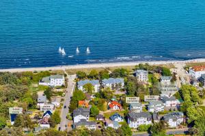 an aerial view of a beach with sailboats in the water at Strandhotel Villa Louisa & Appartementhäuser Villa Josephine und Villa Christine in Juliusruh