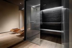 a walk in shower with a glass door at Speronari Suites in Milan