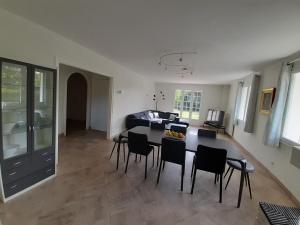 a kitchen and living room with a table and chairs at La Méditation de Thaïs in Vertus