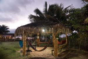 a hut with a hammock and a swing at La Gondola in Montañita