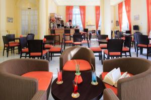 a restaurant with tables and chairs and a bar at Hotel El Paradiso in Menton +21 photos