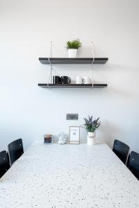 a conference room with a table with chairs and plants at HSA - Shoreditch in London +26 photos