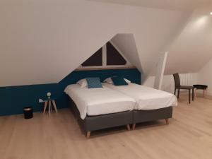 a bedroom with a bed in a attic at La Méditation de Thaïs in Vertus