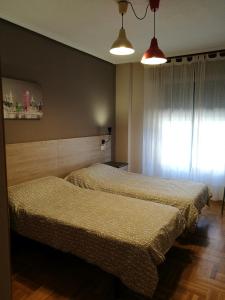 Posteľ alebo postele v izbe v ubytovaní Pension Santiago