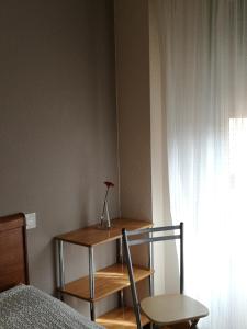 Posteľ alebo postele v izbe v ubytovaní Pension Santiago