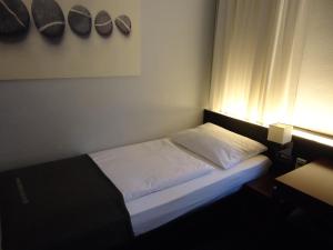 Postel nebo postele na pokoji v ubytování Hotel Concorde