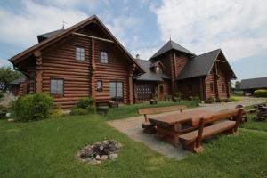 una cabaña de madera con una mesa de picnic delante de ella en Usedlost Gerstein, en Zálesí