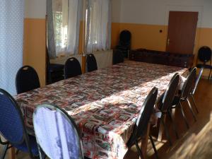 a table and chairs in a room with a table and a table cloth at Chata Pod Hájkem in Vrchlabí