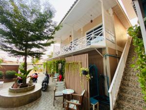 a building with a porch and a table and chairs at Kohlarn Resort in Ko Larn