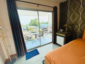 a bedroom with a bed and a door to a patio at Kohlarn Resort in Ko Larn