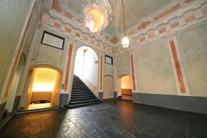 a stairway leading up to a large room with a clock on it at La Superba Rooms & Breakfast in Genoa