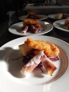 a white plate with food on a table at Hotel Antica Torre in Coredo