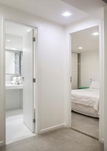 a bedroom with a door leading to a bed at Passeio das Palmeiras in Búzios