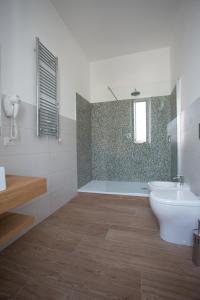 a bathroom with a toilet and a sink and a shower at Guesthouse Porto di Roma in Civitavecchia