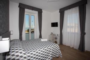 Postel nebo postele na pokoji v ubytování Guesthouse Porto di Roma