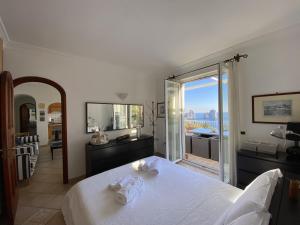 a bedroom with a bed and a view of the ocean at Casa Fiore in Capri