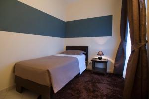 Postel nebo postele na pokoji v ubytování Hotel Il Campanile