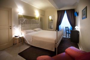 Postel nebo postele na pokoji v ubytování Hotel Il Campanile