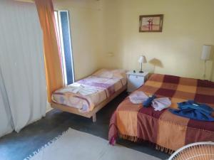 Una cama o camas en una habitación de Hosteria Aura Azul (ex Ser Azul)