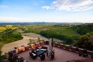 a view from the balcony of a house with a table and chairs at Castello Mellana in Rosignano Monferrato