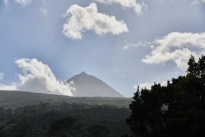 a view of a mountain with clouds in the sky at Villa 4 Seasons in São Roque do Pico