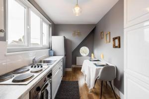 a kitchen with a sink and a stove at The Bluebird - One Bedroom Apartment in Watford in Watford