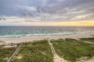 an aerial view of the beach at sunset at Tidewater Condominiums in Orange Beach