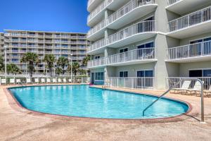 a swimming pool in front of a apartment building at Tradewind 1204 in Orange Beach