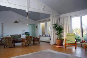 - un salon avec un canapé et des chaises dans l'établissement B&B Koornemoezen, à Zedelgem