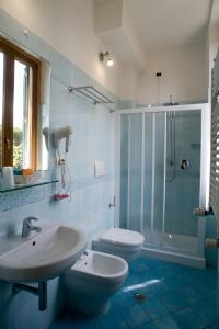 ヴィアレッジョにあるHotel Vittoriaのバスルーム(洗面台、トイレ、シャワー付)