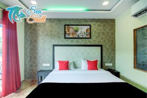 Postel nebo postele na pokoji v ubytování Sea Shell Beach Cottages & Suites