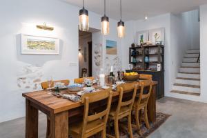 a dining room with a wooden table and chairs at Casa Higueras in Moclín