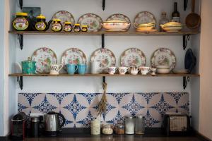 a kitchen with plates and bowls on shelves at Casa Higueras in Moclín