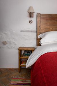 a bedroom with a bed and a table with books at Casa Higueras in Moclín