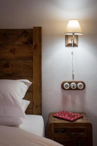 a bedroom with a bed and a table with a lamp at Casa Higueras in Moclín