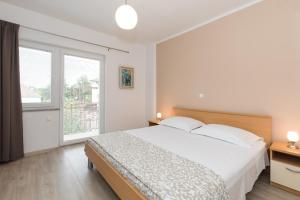 Posteľ alebo postele v izbe v ubytovaní Apartments Laura