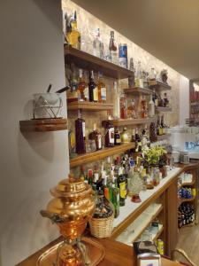 a shelf filled with lots of bottles of alcohol at Hotel Arume in Bóveda