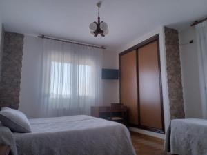 Łóżko lub łóżka w pokoju w obiekcie Arume
