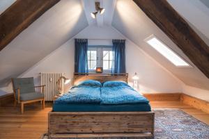 a bedroom with a bed in a attic at Zum-Goldenen-Schaf in Blankenheim