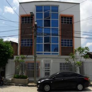 a black car parked in front of a building at Hotel Torres del Parque No3 in Barranquilla