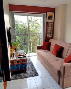 a living room with a couch and a table at Courtyards Peak-Corner Pinestay - at Goshenland Baguio in Baguio