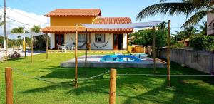 a house with a yard with a pool at GuaratiBahia in Prado