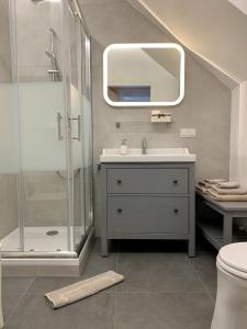 a bathroom with a shower and a sink and a mirror at City-Maisonette in Vienna