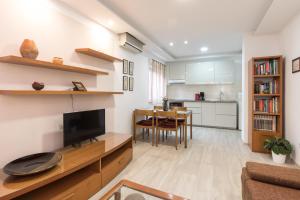a living room with a television and a dining room at Apartments Morozin in Krk