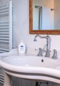 a white sink in a bathroom with a mirror at The Gulf Villa - Lago Maggiore in  Monvalle 